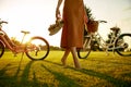 Closeup barefoot young female bicyclist on park grass lawn