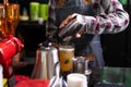 Closeup barista pour mixed drink into a cup.