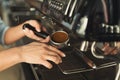 Closeup of barmen hand brewing espresso in professional coffee machine