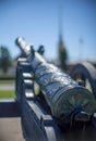 Barrel of old vintage cast iron cannon on wheels and carriages with a blurred background