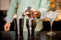 Closeup of bartender hands pouring drink into a jigger to prepare a cocktail Royalty Free Stock Photo