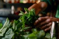 closeup of bartenders hands muddling fresh mint leaves Royalty Free Stock Photo