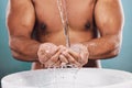 Closeup, basin and man washing hands, water splash and hygiene on blue studio background. Zoom, male and gentleman in Royalty Free Stock Photo