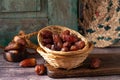 Closeup of a basket of delicious dates on a wooden surface with a blurry background