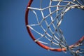 Closeup of basketball basket net of white rope view from underneath against a blue sky Royalty Free Stock Photo