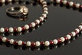 Closeup beads with garnet and white pearls and silver ring