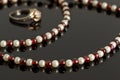 Closeup beads with garnet and white pearls and silver ring Royalty Free Stock Photo