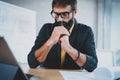 Closeup of bearded male architect wearing eye glasses working on a digital tablet dock at his desk. Professional Royalty Free Stock Photo