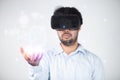 Closeup of bearded young man wearing virtual reality goggles in modern coworking studio. Smartphone using with VR headset Royalty Free Stock Photo