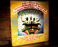 Closeup of The Beatles Magical Mystery Tour Vinyl Record Cover Leaning Against Brick Wall