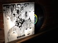 Closeup of The Beatles Revolver Vinyl Record and Cover Leaning Against Brick Wall