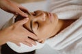 Closeup of beautiful African American woman in spa salon getting face treatment. Royalty Free Stock Photo