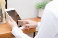 Closeup beautiful asian businesswoman holding tablet, woman hand touch screen using digital tablet computer Royalty Free Stock Photo