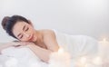 Closeup beautiful asian young  woman lying down on massage beds at Asian luxury spa and wellness center. Royalty Free Stock Photo