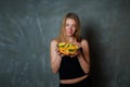 Closeup beautiful blond girl holds deep transparent dish with citrus fruit slices