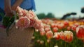 Closeup beautiful blooming flowers in basket. Unknown woman walking with bouquet Royalty Free Stock Photo
