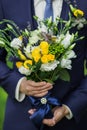 Bouquet of fresh colorful flowers in male hands Royalty Free Stock Photo