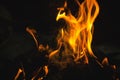 Closeup of a beautiful campfire outdoors at night with a blurry background