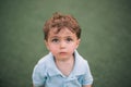 Closeup of a beautiful Caucasian little boy looking ahead with a cute facial expression Royalty Free Stock Photo