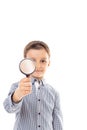 Closeup of a beautiful child looking through a magnifying glass Royalty Free Stock Photo