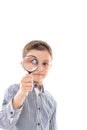 Closeup of a beautiful child looking through a magnifying glass Royalty Free Stock Photo