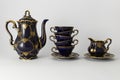 Beautiful cobalt blue colored vintage porcelain tea set with gold ornament Royalty Free Stock Photo