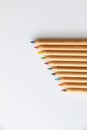 Closeup of beautiful colorful pencils stacked in a row in descending order Royalty Free Stock Photo