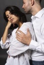 Closeup of a beautiful couple wearing white shirts and jeans. A man passionately hugs a girl. Casual fashionable style. Lifestyle Royalty Free Stock Photo