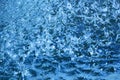 Closeup of beautiful dynamic water surface with falling droplets in blue color. Royalty Free Stock Photo