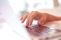 Closeup beautiful female hands typing on keyboard using a laptop in a cafe ,successful business woman,working,,blurred background Royalty Free Stock Photo