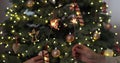 Closeup of beautiful female and man hands holding two stick of holiday sparkler burning isolated at blurry Christmas Royalty Free Stock Photo