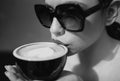 Closeup beautiful girl with coffee. Beauty romantic woman with cup of coffee. Close up woman lip with mouth drink latte. Royalty Free Stock Photo