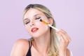 Closeup beautiful girl with flawless applying alluring eye shadow makeup. Royalty Free Stock Photo