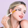 Closeup beautiful girl with flawless applying alluring eye shadow makeup. Royalty Free Stock Photo