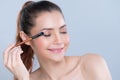 Closeup beautiful girl with flawless applying glamorous eye shadow makeup. Royalty Free Stock Photo