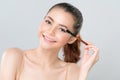 Closeup beautiful girl with flawless applying glamorous eye shadow makeup. Royalty Free Stock Photo