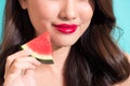 Closeup of the beautiful girl with red lips eating watermelon. Royalty Free Stock Photo