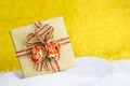 Closeup beautiful gold gift box with rose flower over blurred gold background Royalty Free Stock Photo