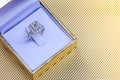Closeup Beautiful and luxury wedding diamond ring in box on gold background Royalty Free Stock Photo