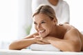 Closeup of beautiful middle aged woman enjoying back massage at spa salon Royalty Free Stock Photo