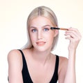 Closeup beautiful personable girl with flawless applying eye shadow makeup. Royalty Free Stock Photo