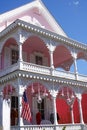 Closeup of a beautiful pink with fancy white trim victorian style house Royalty Free Stock Photo