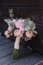 Closeup of beautiful pink rose bouquet held by a gracious bride