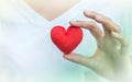 Closeup red heart shape fabric on woman hand Royalty Free Stock Photo