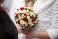 Closeup of a beautiful romantic pink and red roses wedding bouquet in brides hands Royalty Free Stock Photo