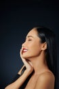 Closeup of beautiful smiling woman touching soft smooth facial skin Royalty Free Stock Photo
