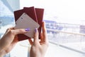 Closeup of beautiful woman hand holding passports and boarding pass tickets at airport terminal. Travel and holiday concept. Termi Royalty Free Stock Photo