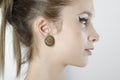 Closeup of beautiful woman profile wearing colorful earrings
