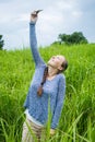 Closeup of beautiful woman taking a selfie on smart phone outdoors in summer. Young woman photographing herself smiling.