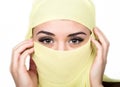 Closeup of beautiful young arabian woman in yellow hijab. Charm and beauty of the East. Royalty Free Stock Photo